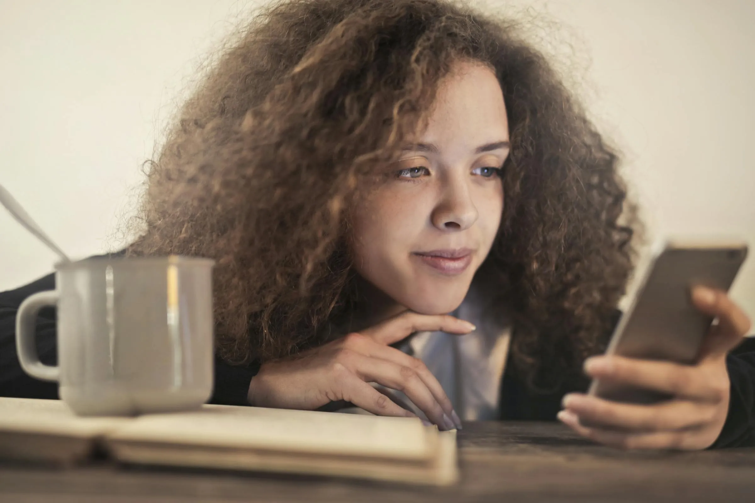Person using smartphone in a Bellingham coffee shop